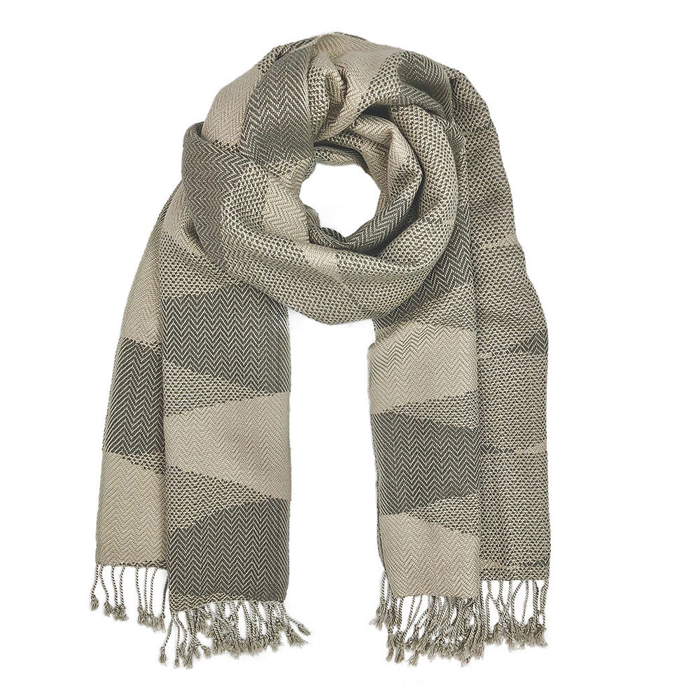 A geometric patterned scarf, beige and gray, with visible tassels at the end.