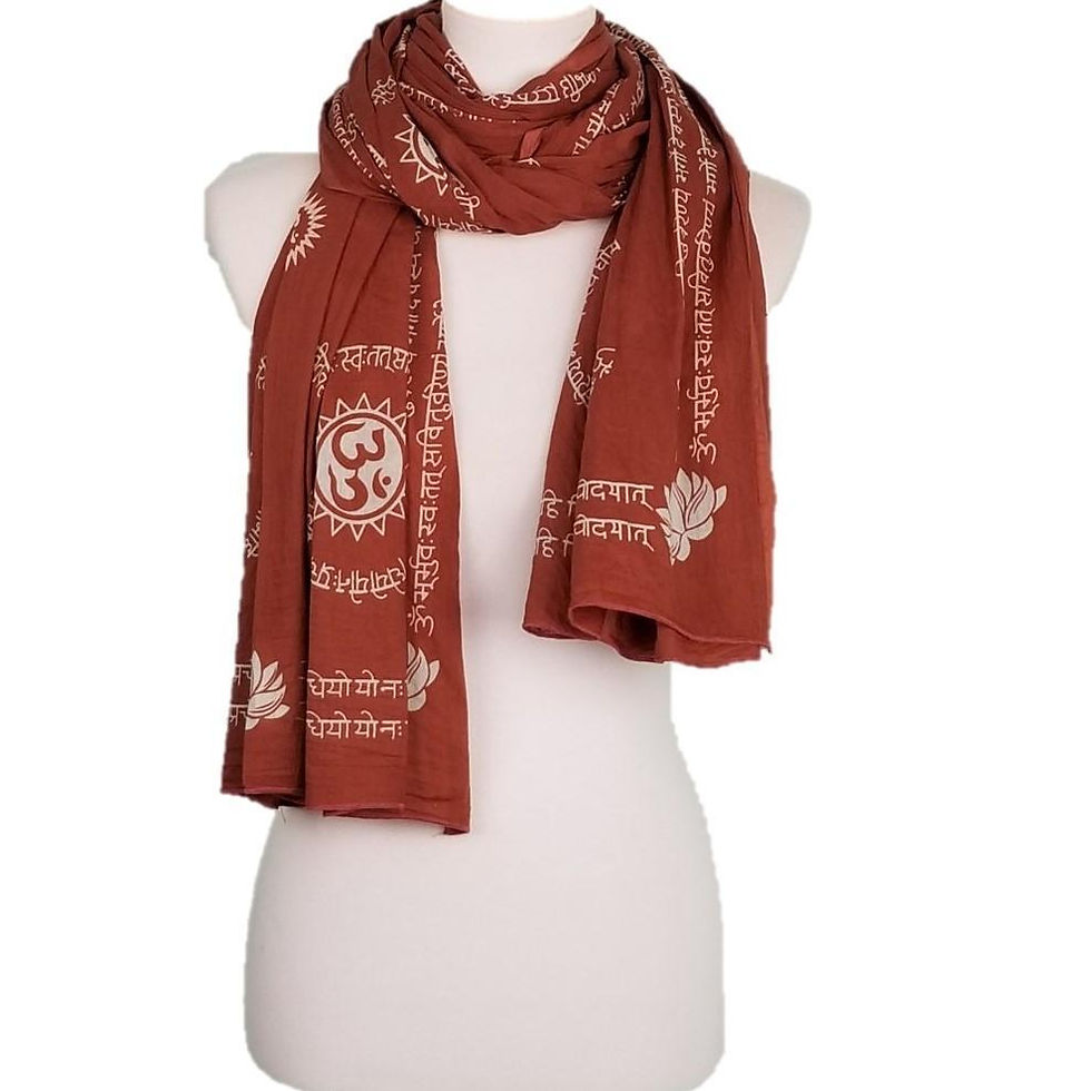 Woman's mannequin wearing a rust-colored scarf with white printed detailed patterns.