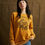 Thumbnail: Woman wearing yellow sweatshirt with Taco Hell text, looking at the camera.