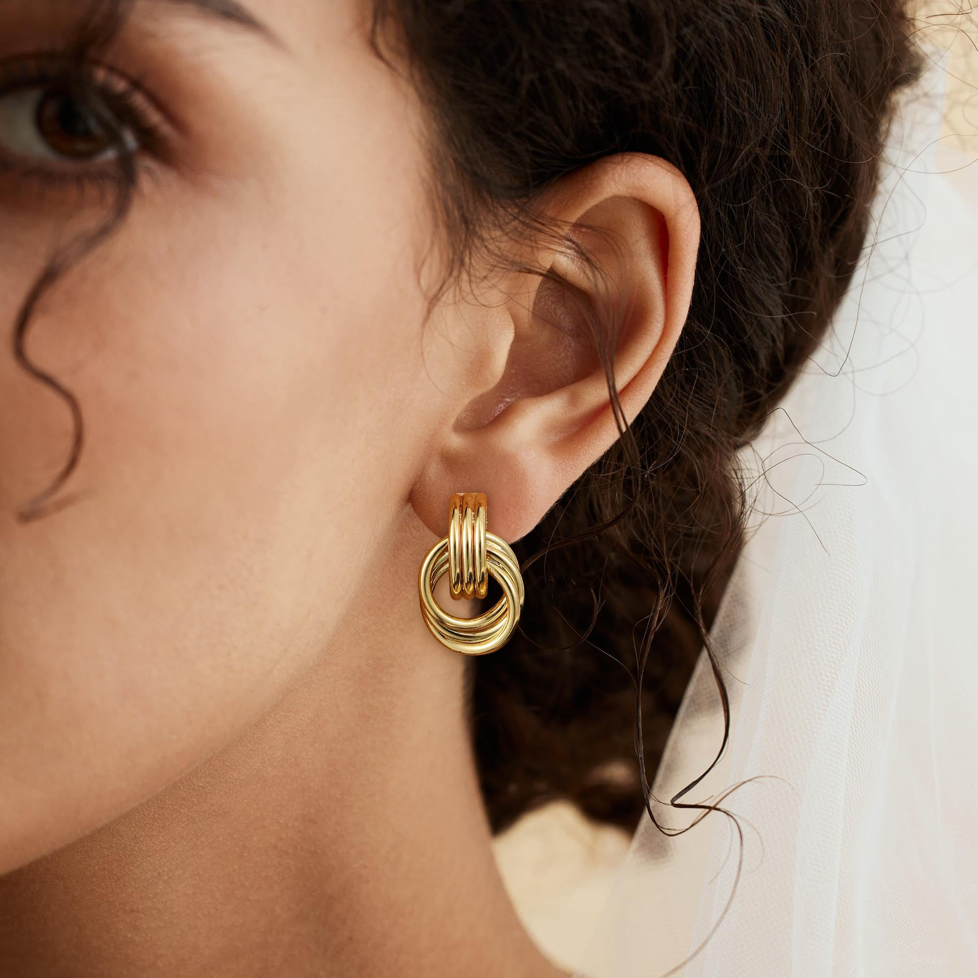Elegant woman wearing gold hoop earrings, close-up shot of her ear
