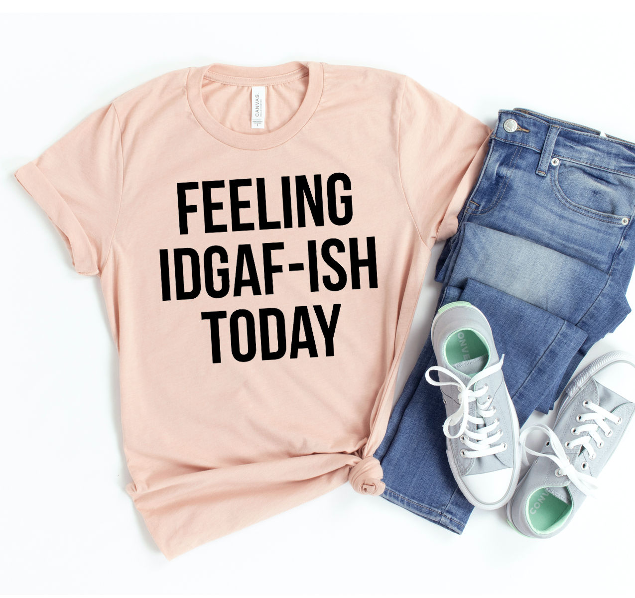 Pink t-shirt with the text "FEELING IDGAF-ISH TODAY" and jeans.