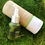 Thumbnail: Humanity Beauty facial serum in glass bottle next to its packaging on moss.