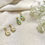 Thumbnail: Two pairs of beautiful gold earrings on a white cloth background.