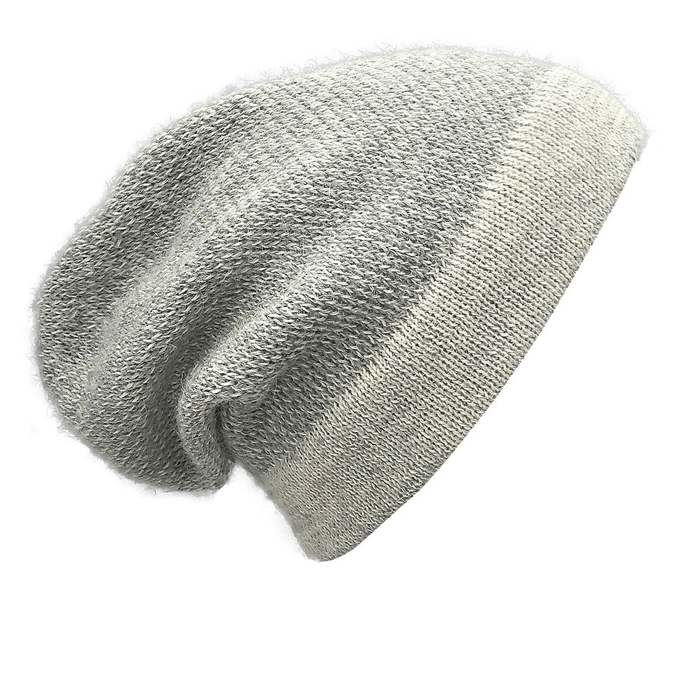 A soft, grey beanie hat, angled on a white surface, showcasing its texture.