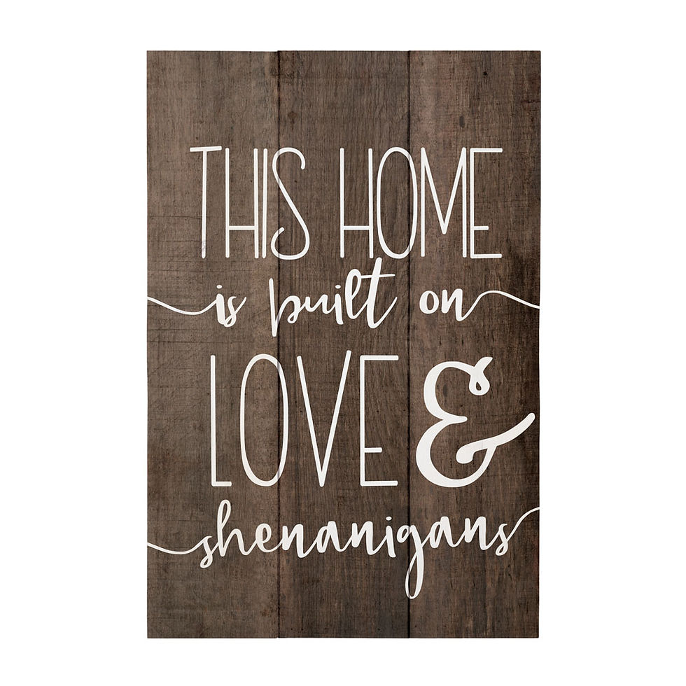 Wooden sign reads: This home is built on love and shenanigans.