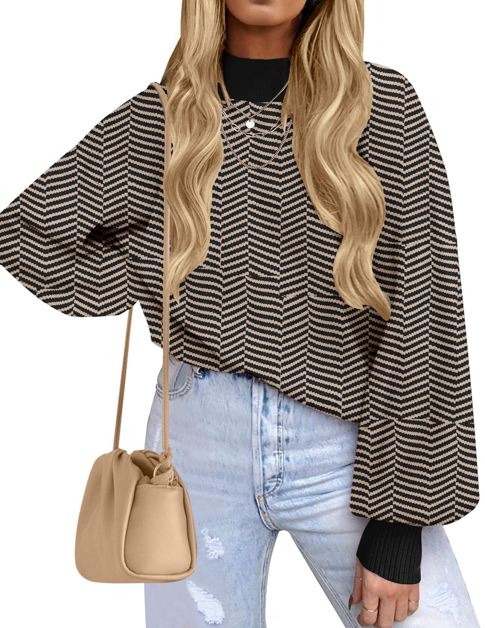 Woman wearing striped long sleeve top with purse and blue jeans