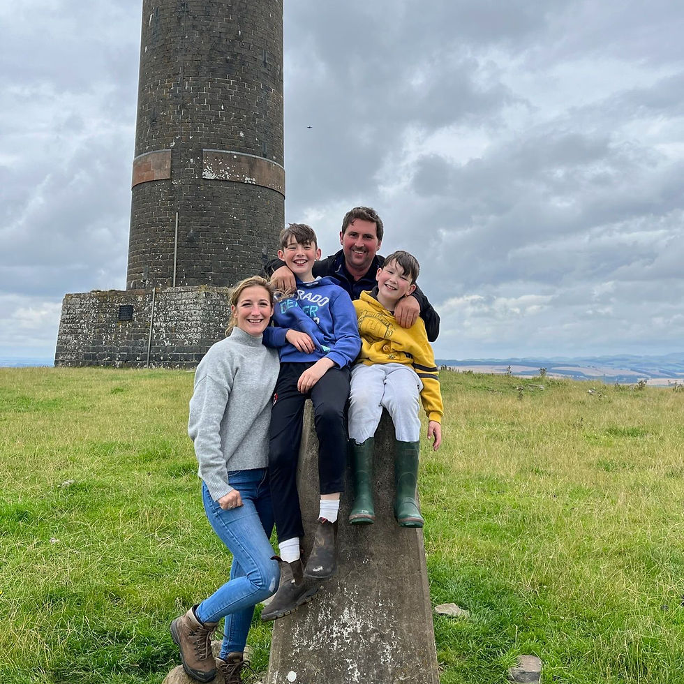 The Hedley's have their photo taken together at a local monument