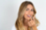 young, attractive woman smiles and holds clear aligners, showing modern orthodontic treatment options at your dentist in Ballard, Hygge Laser Dentistry