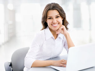 woman at computer smiling brightly