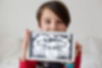 child holding a dental x-ray