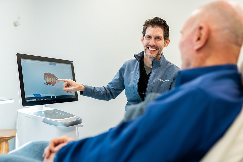 Dr. Bryant Anderson, DDS consulting with a patient before a procedure.