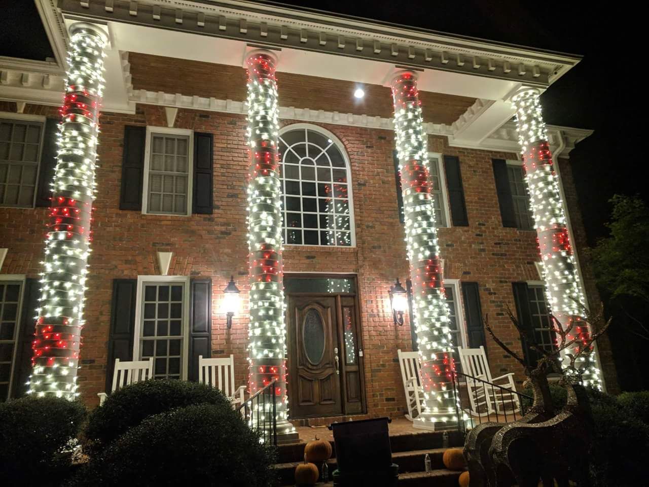 Lighted wreath and garland holiday décor at a building entrance