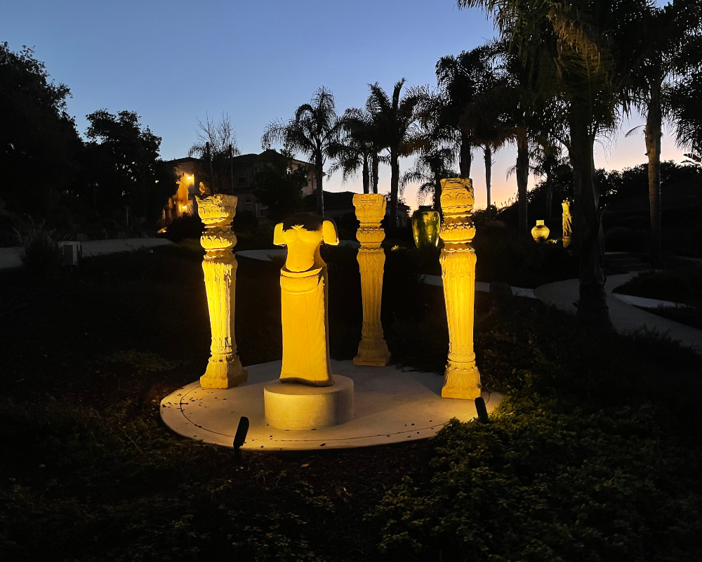 Uplit palms and garden sculptures