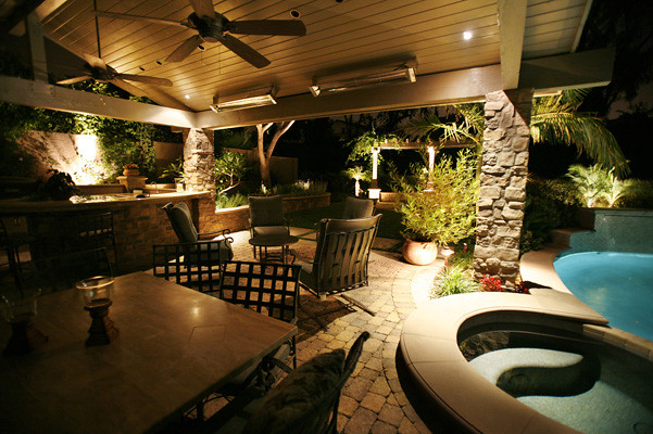 Covered patio and pool with warm lighting