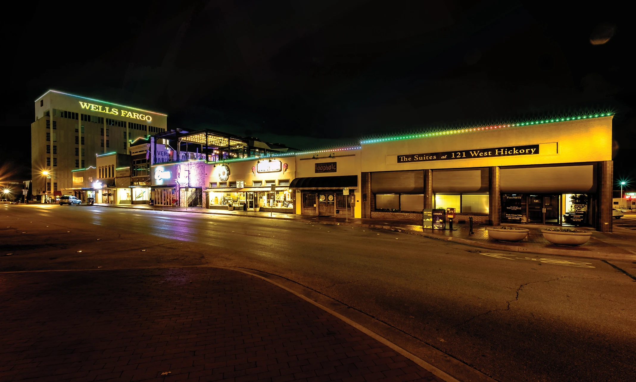 Commercial building decorated with holiday lighting at night