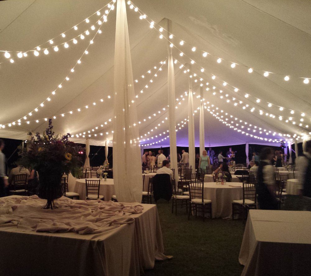 Wedding reception tent with draped string lighting
