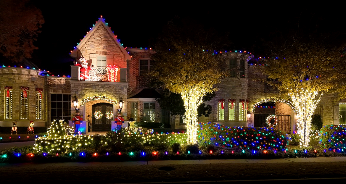 Commercial building decorated with holiday lighting at night