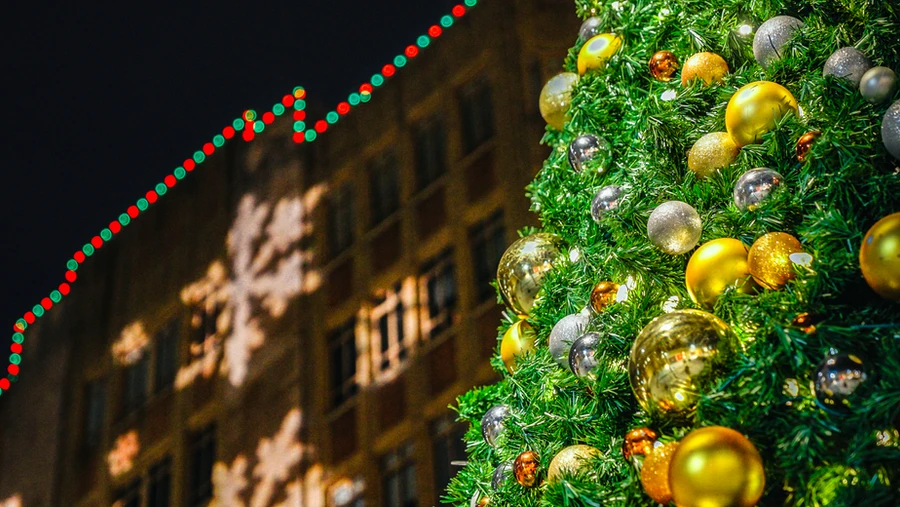 Lighted wreath and garland holiday décor at a building entrance