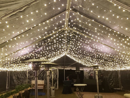 Clear-top event tent filled with twinkle lights