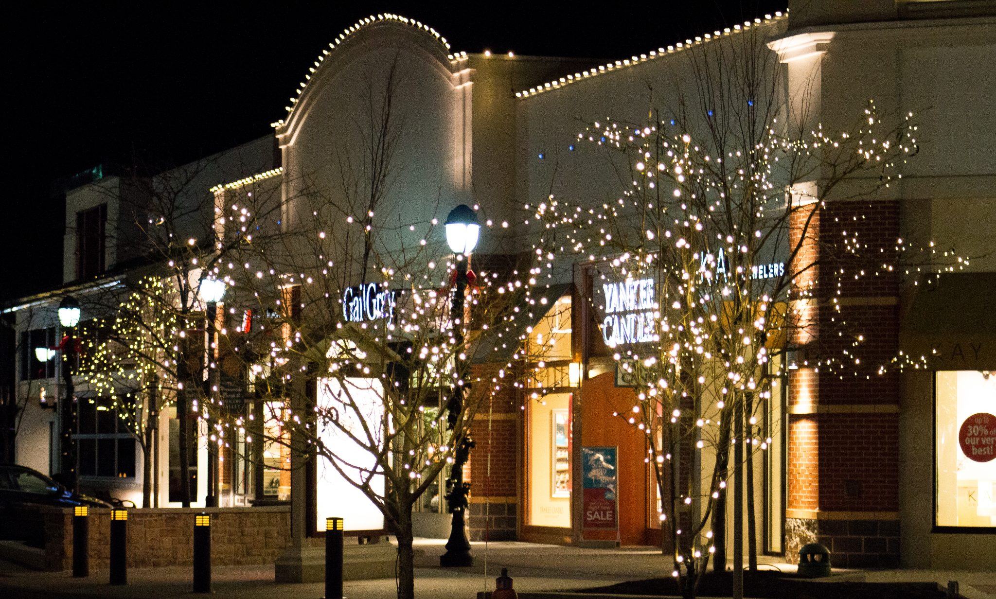 Commercial building decorated with holiday lighting at night