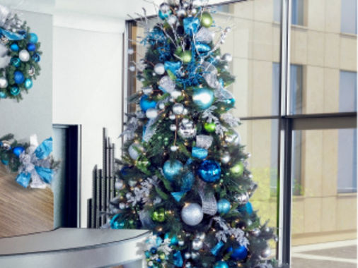 Blue and silver decorated Christmas tree in an office lobby
