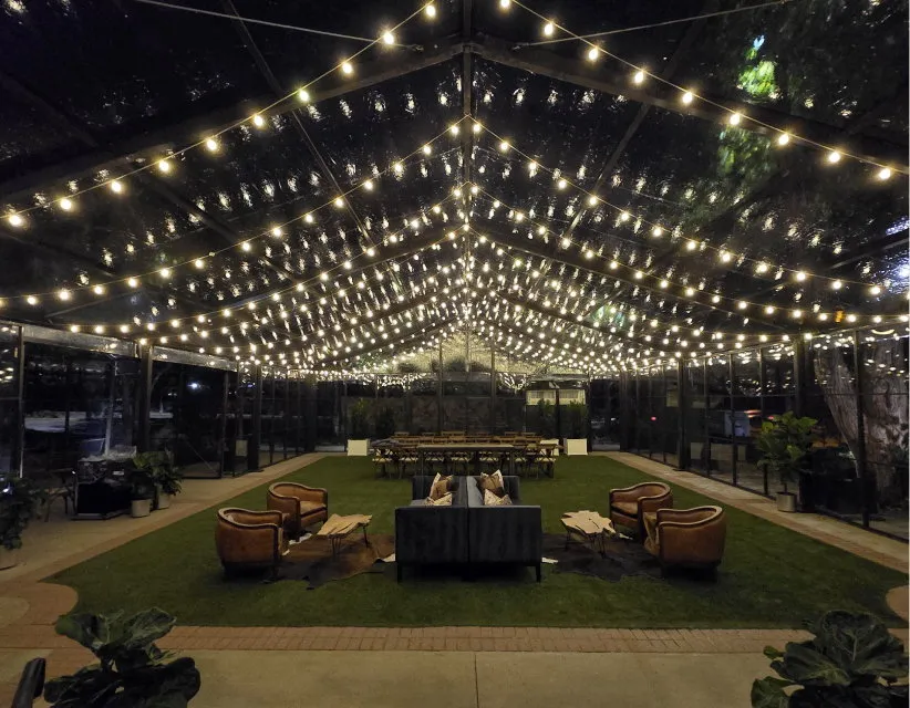 Outdoor patio covered by a canopy of string lights