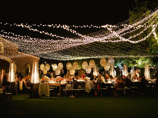 Wedding reception under a canopy of overhead string lights