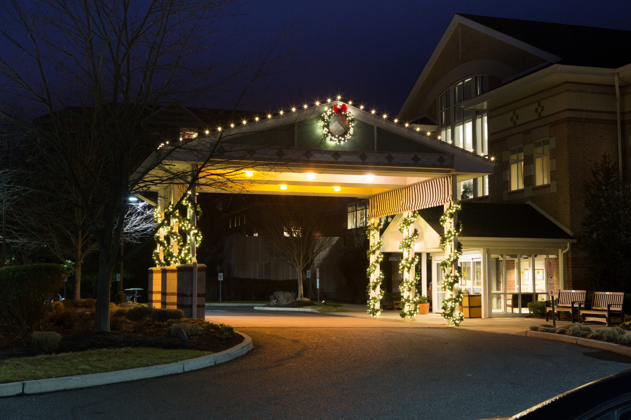 Commercial building decorated with holiday lighting at night