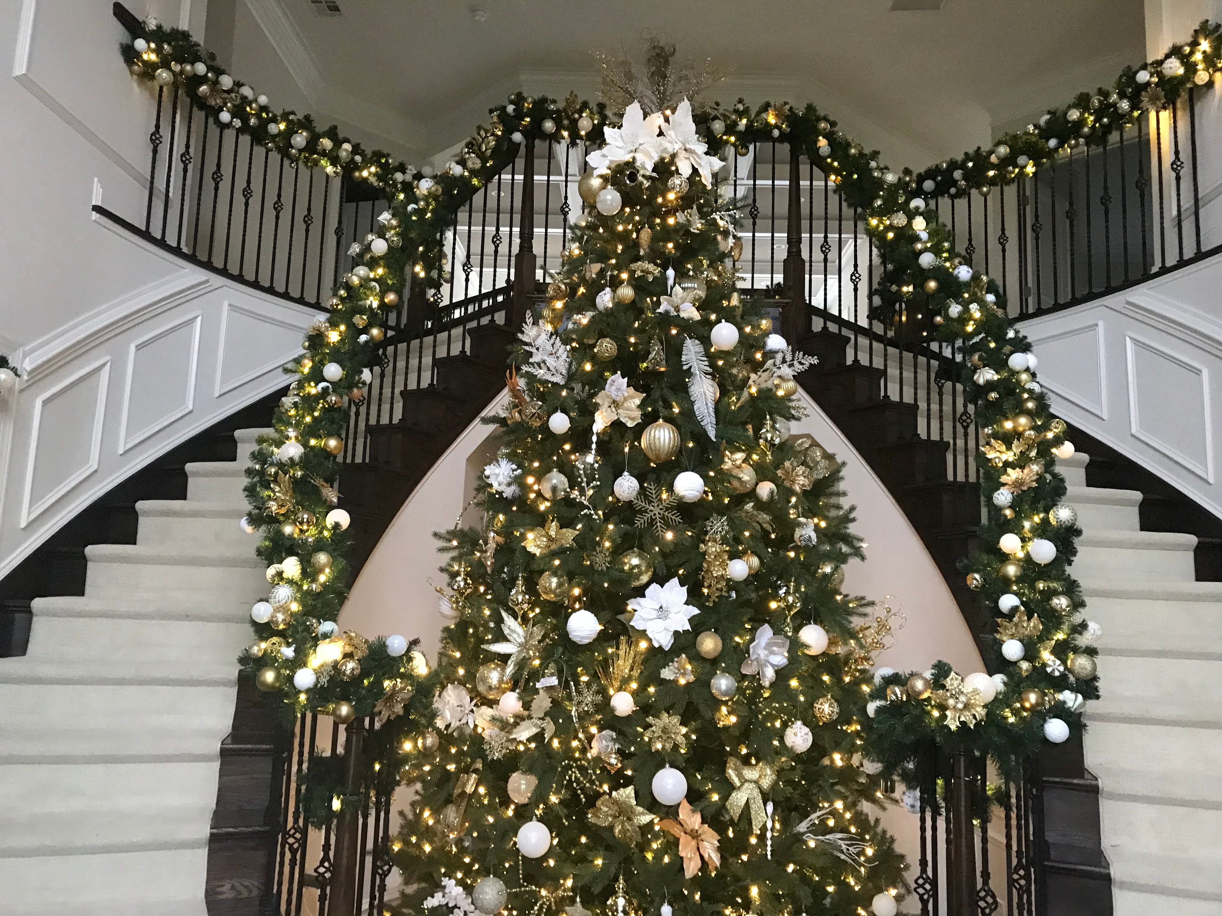 Grand staircase with garland and a decorated tree