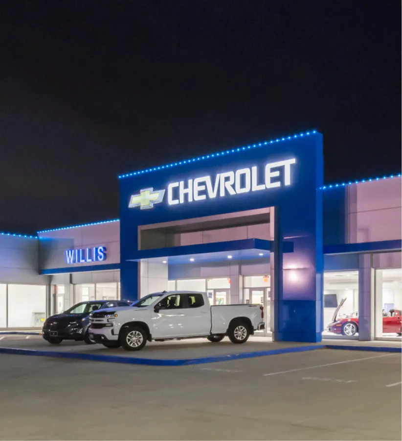 Chevrolet dealership building and sign at dusk