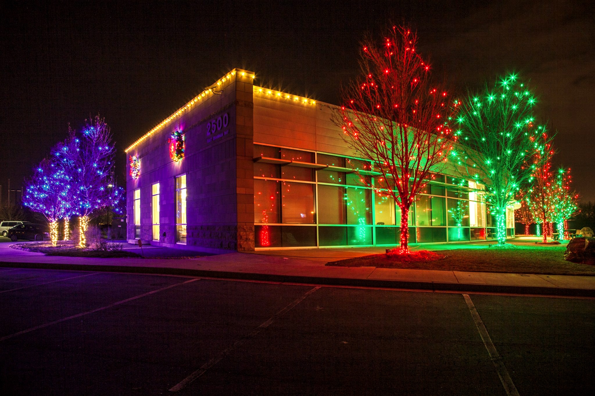 Commercial building decorated with holiday lighting at night