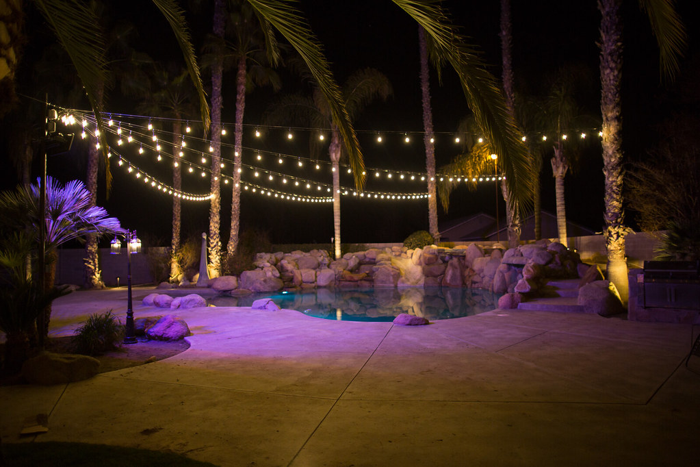 Pool patio with string lights at night