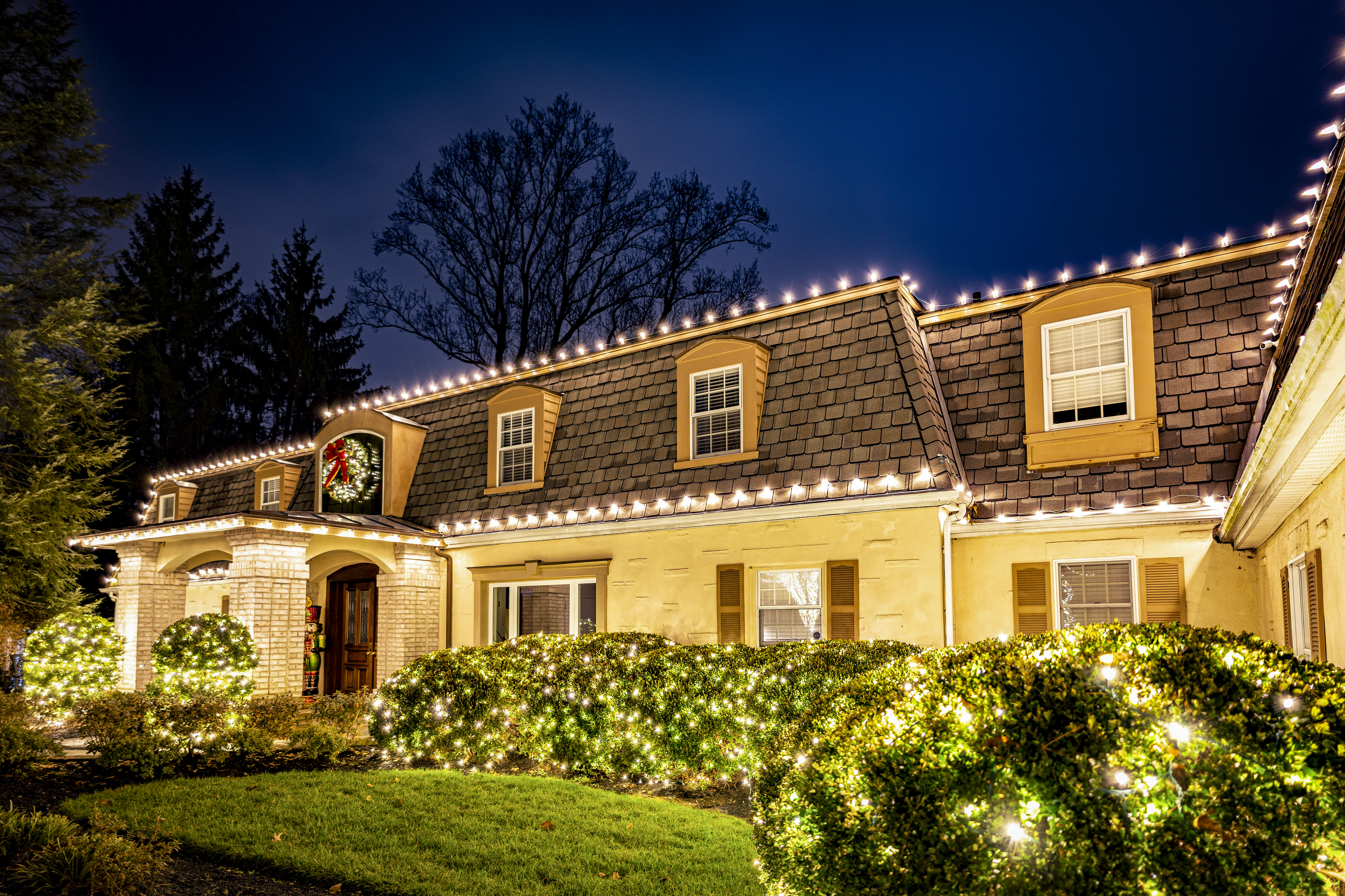 Gambrel-roof home with roofline lights