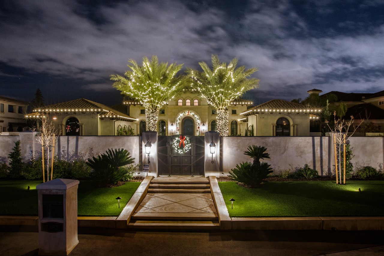 Courtyard home with palms and holiday lighting