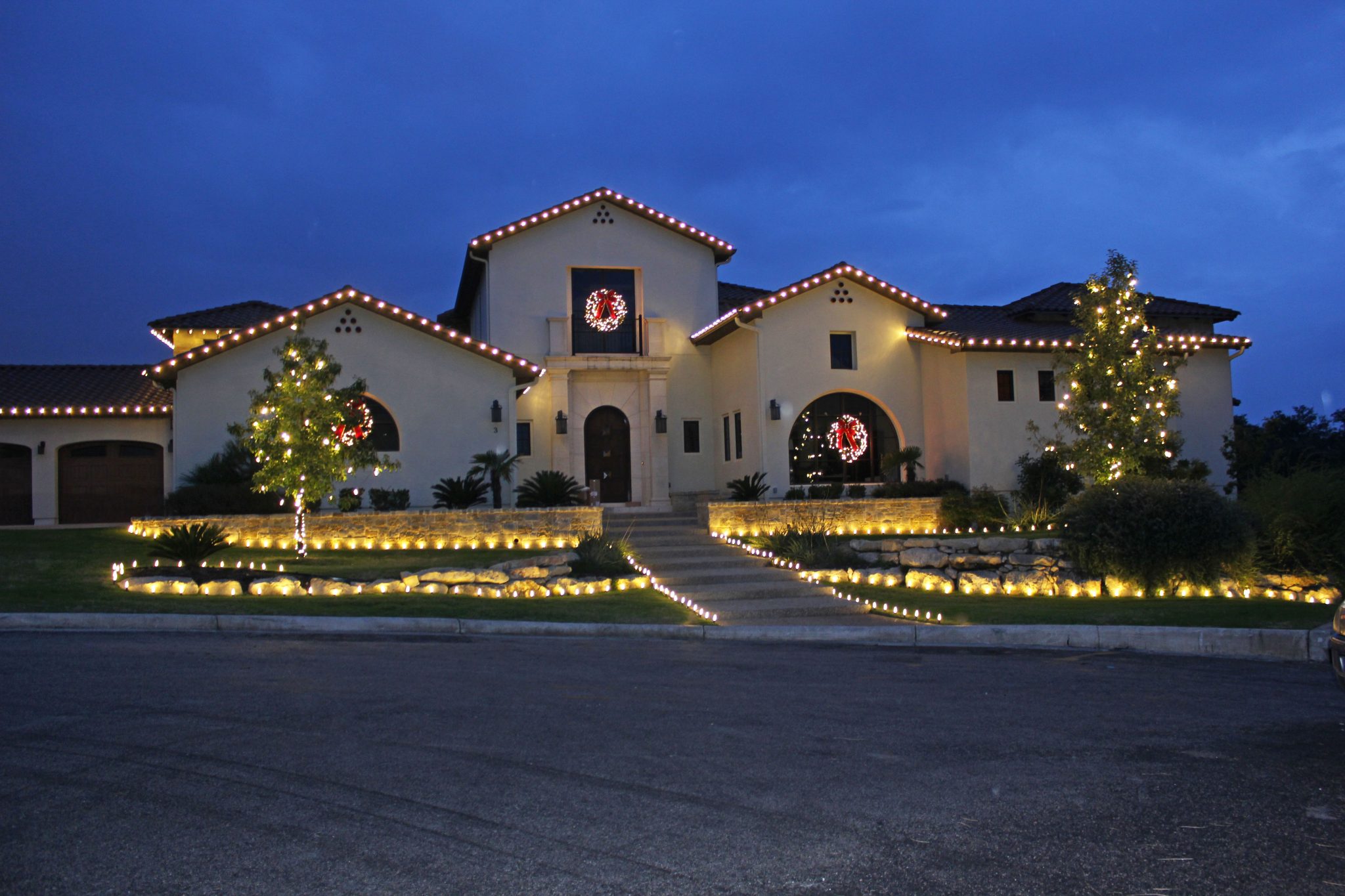 Permanent white roofline lighting on a modern home