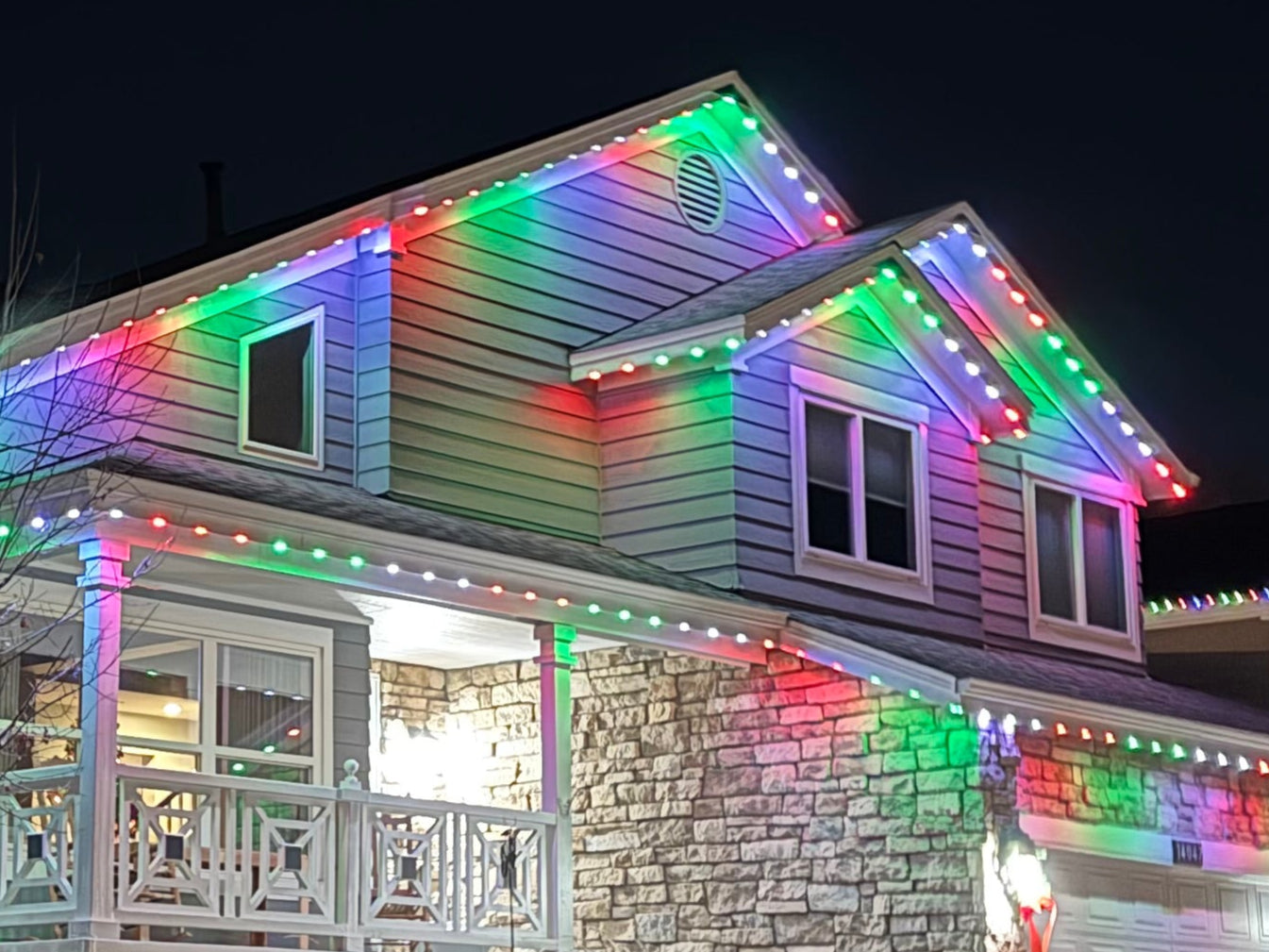 Home with multicolor permanent lighting along every roofline