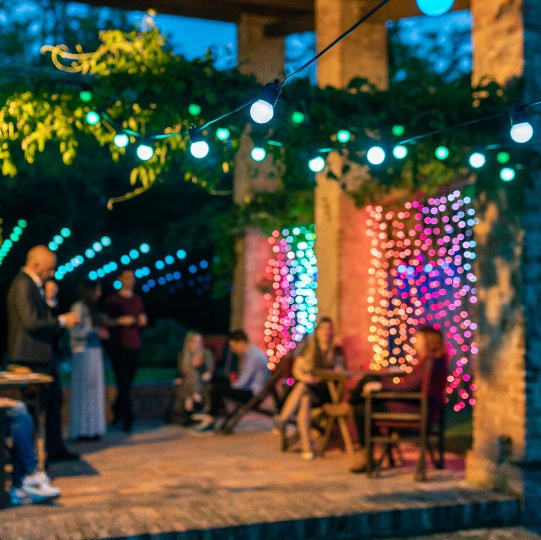 Event guests beside a programmable light curtain