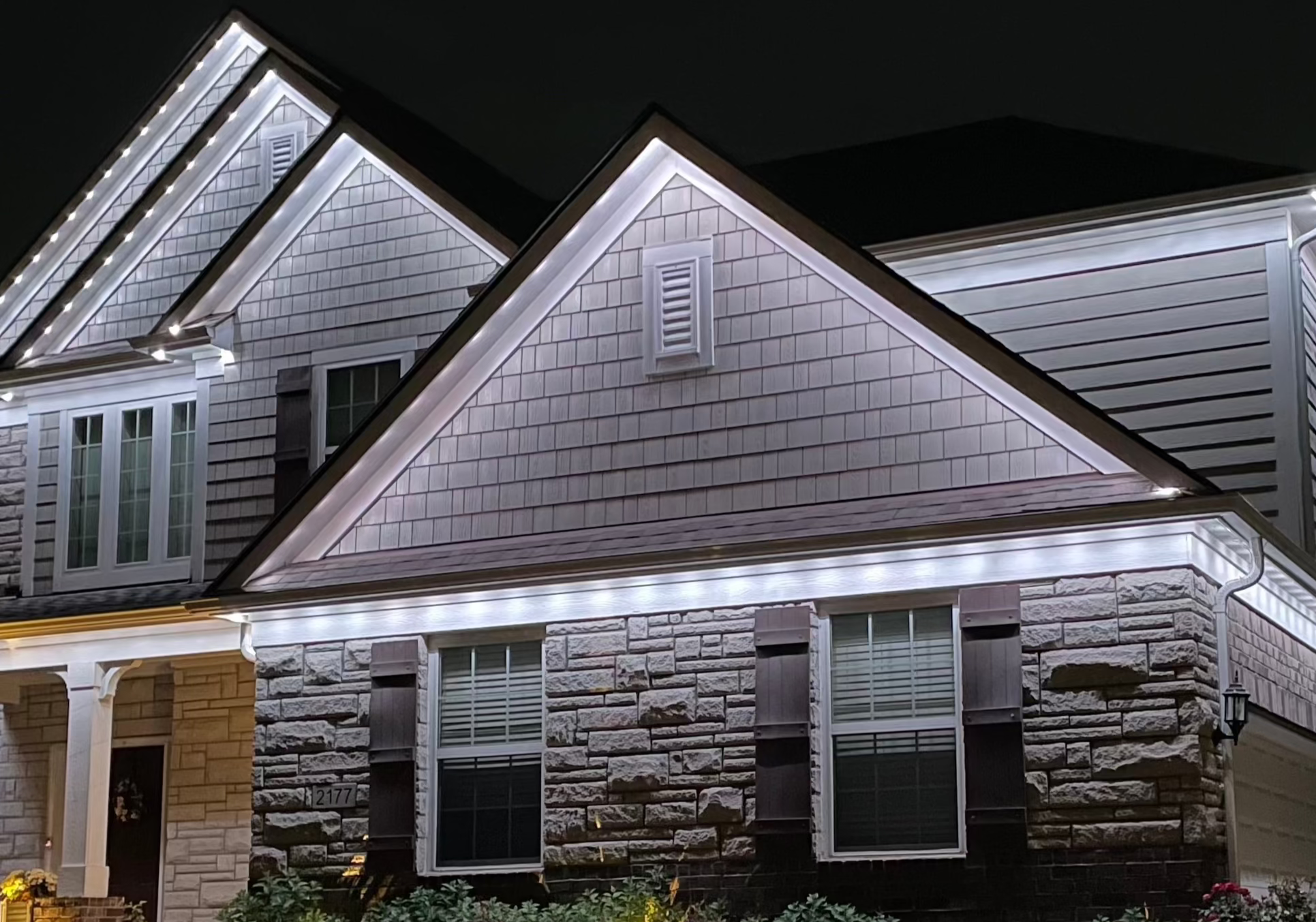Gabled home with warm-white permanent roofline lighting