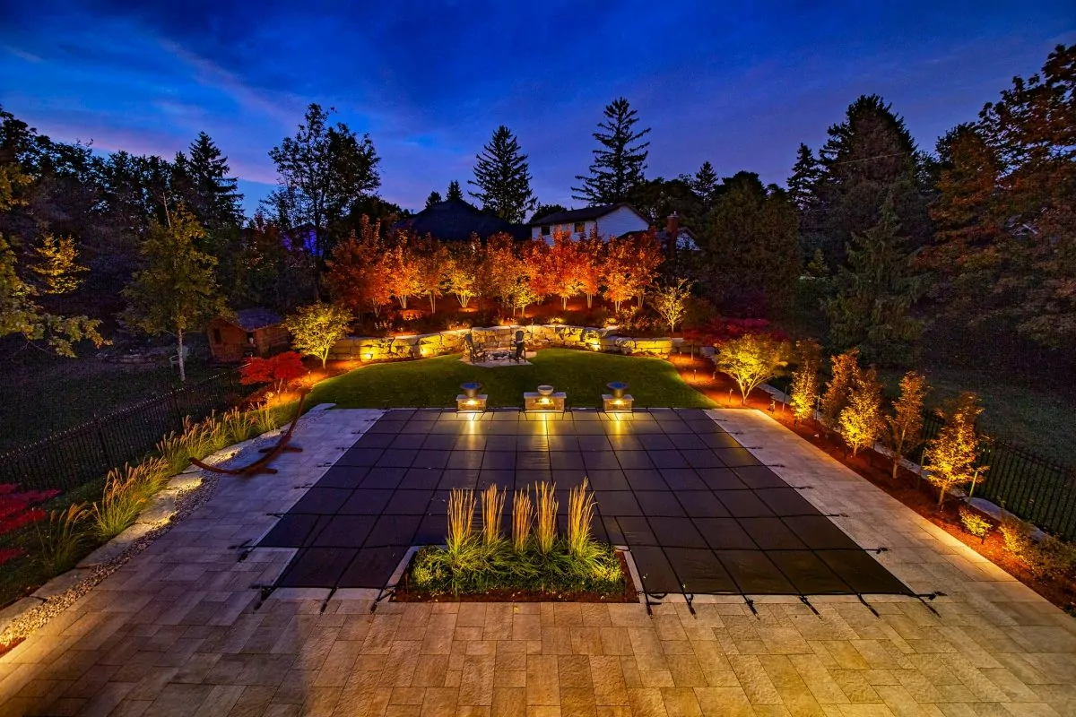 Low-voltage landscape lighting on a home and yard at night