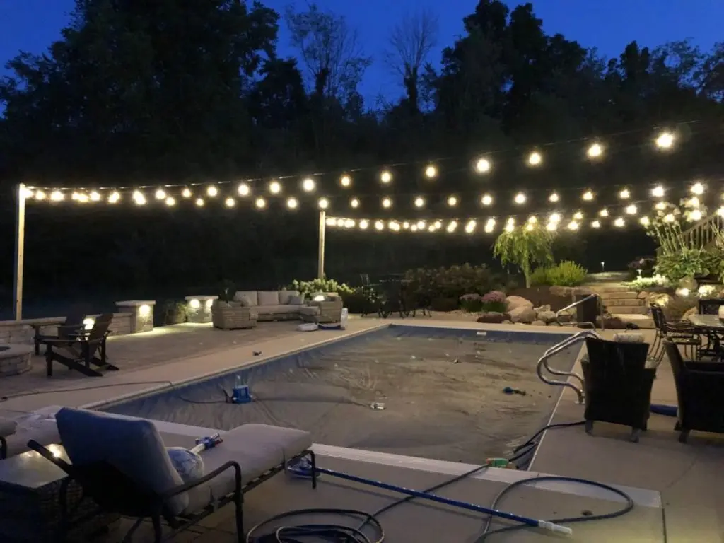 Pool deck framed by bistro string lights