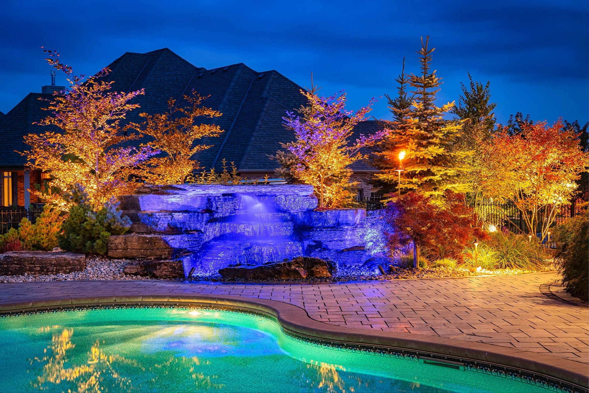 Low-voltage landscape lighting on a home and yard at night