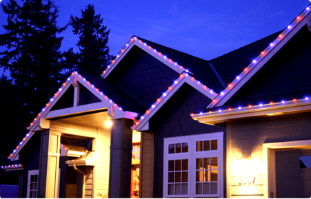 Home with white permanent lighting along gables