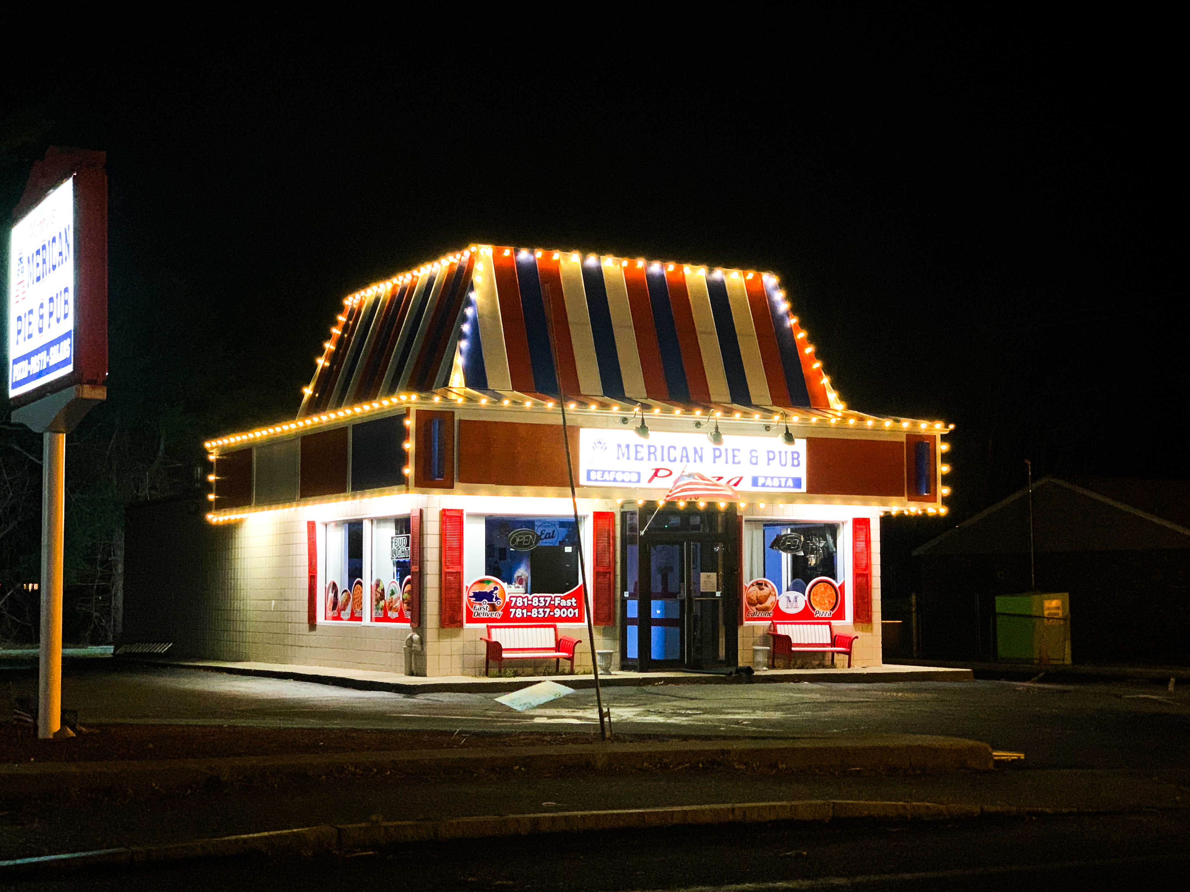 Commercial building lit with holiday lighting at night