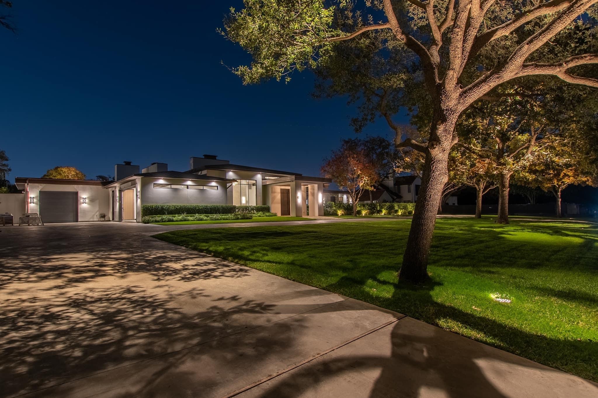 Oak tree and long driveway lit with landscape lighting
