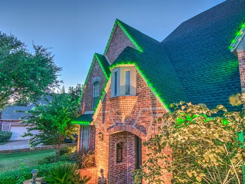 Home with permanent roofline lighting set to green