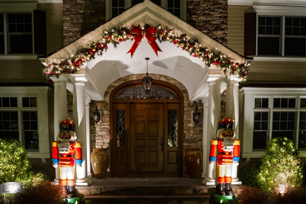 Lighted wreath and garland holiday décor at a building entrance