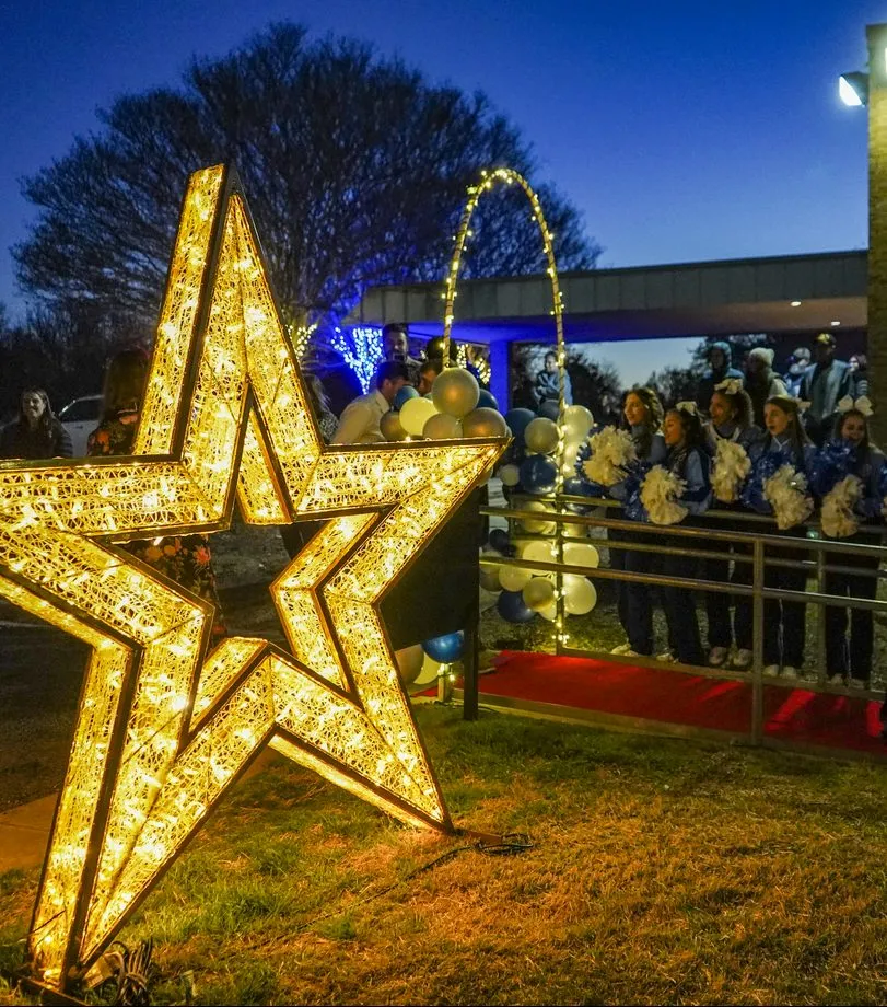 Large lighted star sculpture at a holiday light display