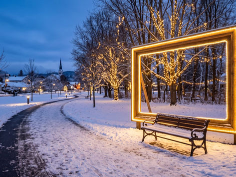 Lit photo frame and bench photo-op display in a winter park