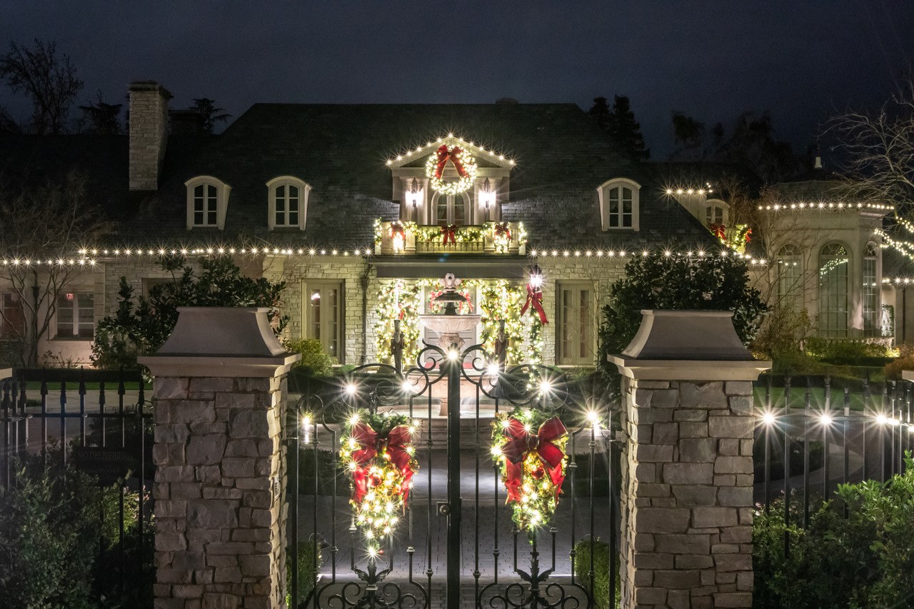 Gated home entry with wreaths and lights