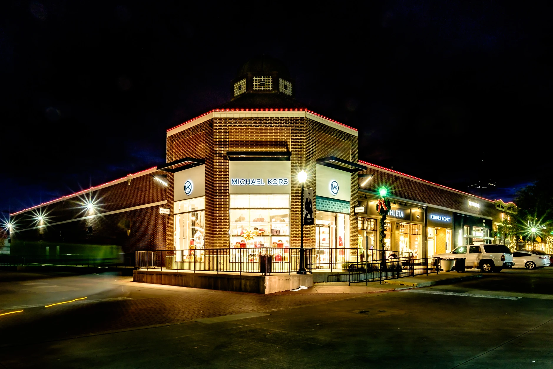Commercial building decorated with holiday lighting at night